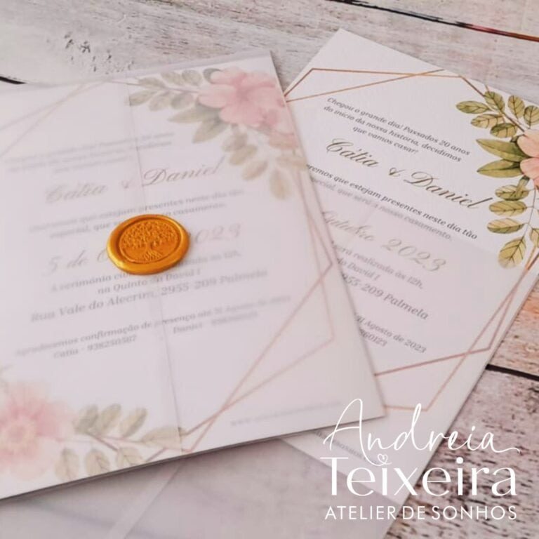 Cadeado de cera dourada sobre convite de casamento com detalhes florais e linhas douradas, em fundo de madeira clara.